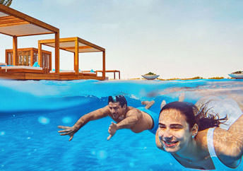Couple swimming underwater in beach club hotel